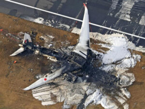 An aerial view shows burnt Japan Airlines' Airbus A350 plane after a collision with a Japan Coast Guard aircraft at Haneda International Airport in Tokyo, Japan January 3, 2024. LivemintUSA