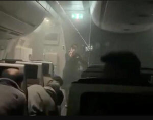 People sit amid smoke inside the Japan Airlines' A350 airplane in this screen grab obtained from social media LivemintUSA